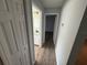 Hallway view to bedroom and bathroom featuring wood floor at 6608 Madeira Ave, Lakeland, FL 33811