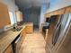 Kitchen with stainless steel appliances, granite counters, and wood cabinets at 6608 Madeira Ave, Lakeland, FL 33811