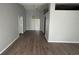 Living room with hardwood flooring and natural light coming through the sliding doors at 6608 Madeira Ave, Lakeland, FL 33811