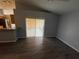 Living room with an open floor plan leading to the kitchen with stainless appliances at 6608 Madeira Ave, Lakeland, FL 33811
