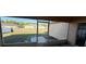 View from screened in porch overlooking a large grassy backyard and wood fence at 6608 Madeira Ave, Lakeland, FL 33811