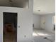 Newly renovated room with fresh paint and view into the kitchen and doorway at 6608 Madeira Ave, Lakeland, FL 33811