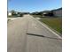 Wide street view lined with well-maintained lawns and residences on a sunny day at 6608 Madeira Ave, Lakeland, FL 33811