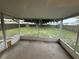 A screened back porch with a view of the expansive backyard and mature trees at 6616 Shepherd Oaks St, Lakeland, FL 33811