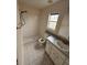 A bright bathroom with a tiled shower and single sink vanity at 6616 Shepherd Oaks St, Lakeland, FL 33811