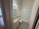 Bathroom with single sink vanity and shower at 6616 Shepherd Oaks St, Lakeland, FL 33811