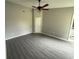 Neutral bedroom features vaulted ceiling, fan, and gray laminate flooring at 6616 Shepherd Oaks St, Lakeland, FL 33811
