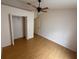 Spacious bedroom with wood floors, ceiling fan, and ample closet space at 6616 Shepherd Oaks St, Lakeland, FL 33811