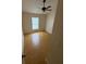 Cozy bedroom with hardwood floors, ceiling fan, and bright natural light from window at 6616 Shepherd Oaks St, Lakeland, FL 33811