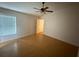 Bedroom with wood floors, bright window, and ceiling fan at 6616 Shepherd Oaks St, Lakeland, FL 33811