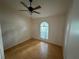 Bright bedroom with arched window and hardwood floors at 6616 Shepherd Oaks St, Lakeland, FL 33811
