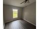Bedroom features dark flooring, neutral paint, and a window view of the backyard at 6616 Shepherd Oaks St, Lakeland, FL 33811