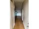 Bright hallway features wood-look flooring and leads to the living area at 6616 Shepherd Oaks St, Lakeland, FL 33811