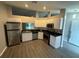 Efficient kitchen design features stainless steel appliances, bright white cabinets and hard surface countertops at 6616 Shepherd Oaks St, Lakeland, FL 33811