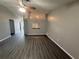 Bright living room with vaulted ceilings, dark flooring, and an open layout to the kitchen at 6616 Shepherd Oaks St, Lakeland, FL 33811