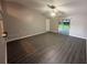 Open-concept living room with vaulted ceiling, fan, and sliding glass door to outdoor area at 6616 Shepherd Oaks St, Lakeland, FL 33811