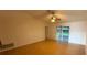 Spacious living room featuring a ceiling fan and access to the patio at 6616 Shepherd Oaks St, Lakeland, FL 33811