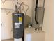 Utility room featuring a water heater and air conditioning unit at 6616 Shepherd Oaks St, Lakeland, FL 33811