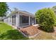 A screened-in lanai overlooks the backyard at 7214 Se 171St Brookhaven Pl, The Villages, FL 32162