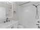 Bathroom featuring a shower-tub combination with black fixtures and a white marble countertop at 7214 Se 171St Brookhaven Pl, The Villages, FL 32162