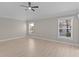 Bedroom featuring neutral paint, light wood floors, ceiling fan, and natural light at 7214 Se 171St Brookhaven Pl, The Villages, FL 32162