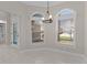 Bright breakfast nook featuring arched windows, modern light fixture, and access to the lanai at 7214 Se 171St Brookhaven Pl, The Villages, FL 32162