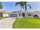 Well-maintained single-Gathering home with two palm trees and a lush green lawn at 7214 Se 171St Brookhaven Pl, The Villages, FL 32162