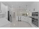 Open kitchen featuring stainless steel appliances, ample cabinets, and a breakfast bar at 7214 Se 171St Brookhaven Pl, The Villages, FL 32162