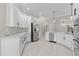 Kitchen with stainless steel appliances, quartz countertops, and white cabinets at 7214 Se 171St Brookhaven Pl, The Villages, FL 32162