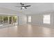 Bright living room featuring vaulted ceilings, light wood floors and sliding glass doors to lanai at 7214 Se 171St Brookhaven Pl, The Villages, FL 32162