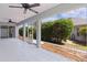 View of the screened-in patio with tiled floors, three ceiling fans and views of the landscaped yard at 7214 Se 171St Brookhaven Pl, The Villages, FL 32162