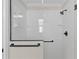 Tiled shower with glass door, rainfall shower head, and built in niche at 7214 Se 171St Brookhaven Pl, The Villages, FL 32162
