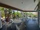 Spacious covered balcony with seating overlooking a tropical pool area, offers a relaxing outdoor space at 7320 Westpointe Blvd # 531, Orlando, FL 32835