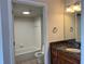 Well-lit bathroom with granite counters, tiled floors, and a shower and tub combo at 7320 Westpointe Blvd # 531, Orlando, FL 32835