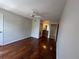 A large bedroom with a ceiling fan, dark hardwood flooring, and an ensuite bathroom at 7320 Westpointe Blvd # 531, Orlando, FL 32835