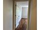 Hallway entrance to bedroom featuring hardwood floors, neutral walls, and bright light at 7320 Westpointe Blvd # 531, Orlando, FL 32835