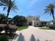 Elegant clubhouse with circular driveway, landscaping, and arched entryway provides a welcoming community space at 7320 Westpointe Blvd # 531, Orlando, FL 32835