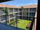 View from the balcony overlooking a well maintained community courtyard with lush landscaping at 7320 Westpointe Blvd # 531, Orlando, FL 32835