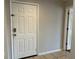 A view of the front door with tiled floor and a glimpse into another room, bright and tidy at 7320 Westpointe Blvd # 531, Orlando, FL 32835