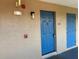 Close-up view of a blue front door with unit number, security features, and an outdoor light fixture at 7320 Westpointe Blvd # 531, Orlando, FL 32835