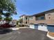 Exterior view of a condo with garage, balcony, and neatly arranged parking space on a sunny day at 7320 Westpointe Blvd # 531, Orlando, FL 32835
