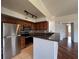 Kitchen with stainless steel appliances, dark wood cabinets, granite countertops, and tile backsplash at 7320 Westpointe Blvd # 531, Orlando, FL 32835