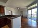 Open living space with wood floors, breakfast bar, and sliding glass doors leading to a balcony with views at 7320 Westpointe Blvd # 531, Orlando, FL 32835