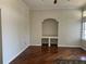 Bright living area with dark wood floors, built-in shelving, and large windows at 7320 Westpointe Blvd # 531, Orlando, FL 32835