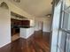 Bright living room with dark wood floors, ceiling fan, and view of kitchen with stainless appliances and granite countertops at 7320 Westpointe Blvd # 531, Orlando, FL 32835