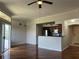 Bright, open-concept living room featuring hardwood floors and stainless steel appliances at 7320 Westpointe Blvd # 531, Orlando, FL 32835