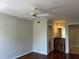 Bedroom featuring hardwood floors and an ensuite bathroom with tiled floors and granite counters at 7320 Westpointe Blvd # 531, Orlando, FL 32835