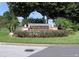 Entrance sign for Bermuda Dunes, a luxury condominium community with beautiful landscaping at 7320 Westpointe Blvd # 531, Orlando, FL 32835