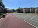 Well-maintained tennis court provides a recreational space for residents, with apartment buildings in the background at 7320 Westpointe Blvd # 531, Orlando, FL 32835