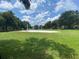 Outdoor beach volleyball court surrounded by lush green lawn offers a recreational amenity for residents at 7320 Westpointe Blvd # 531, Orlando, FL 32835